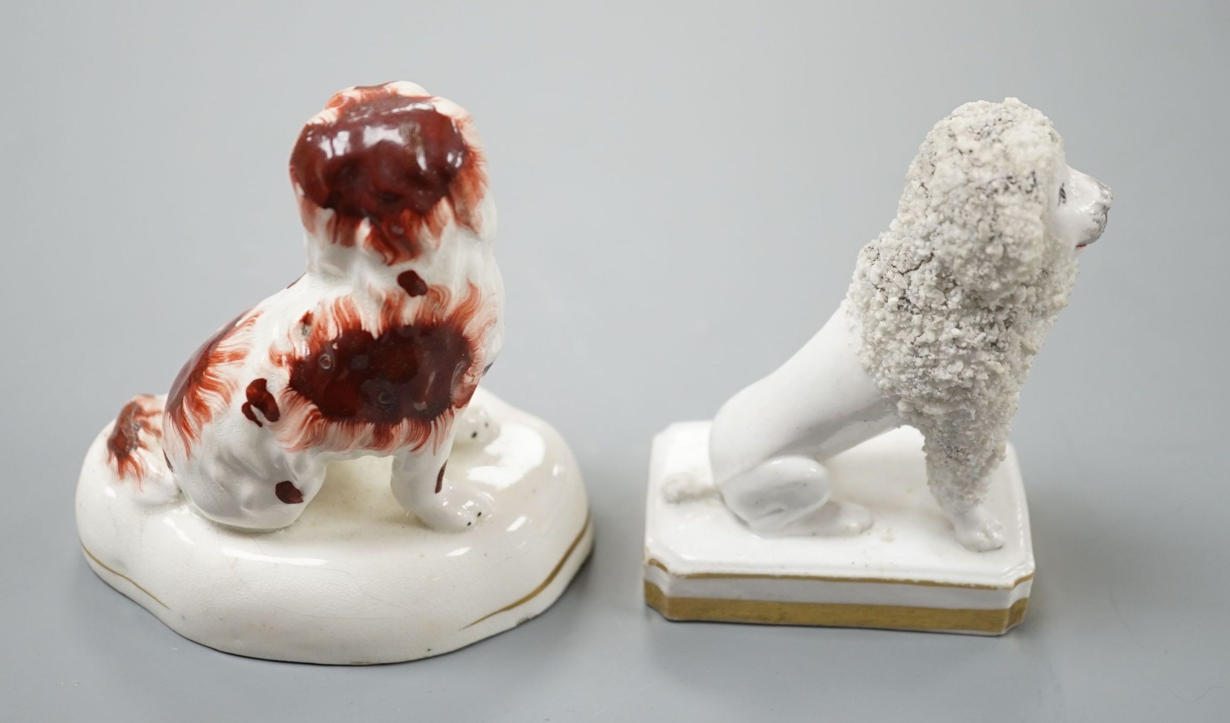 An unusual Staffordshire porcelain model of a seated poodle, 8.8cm high and a similar porcelain model of a seated King Charles Spaniel, c.1835-50, impressed mark ‘H’, Cf. Dennis G.Rice Dogs in English porcelain, colour p